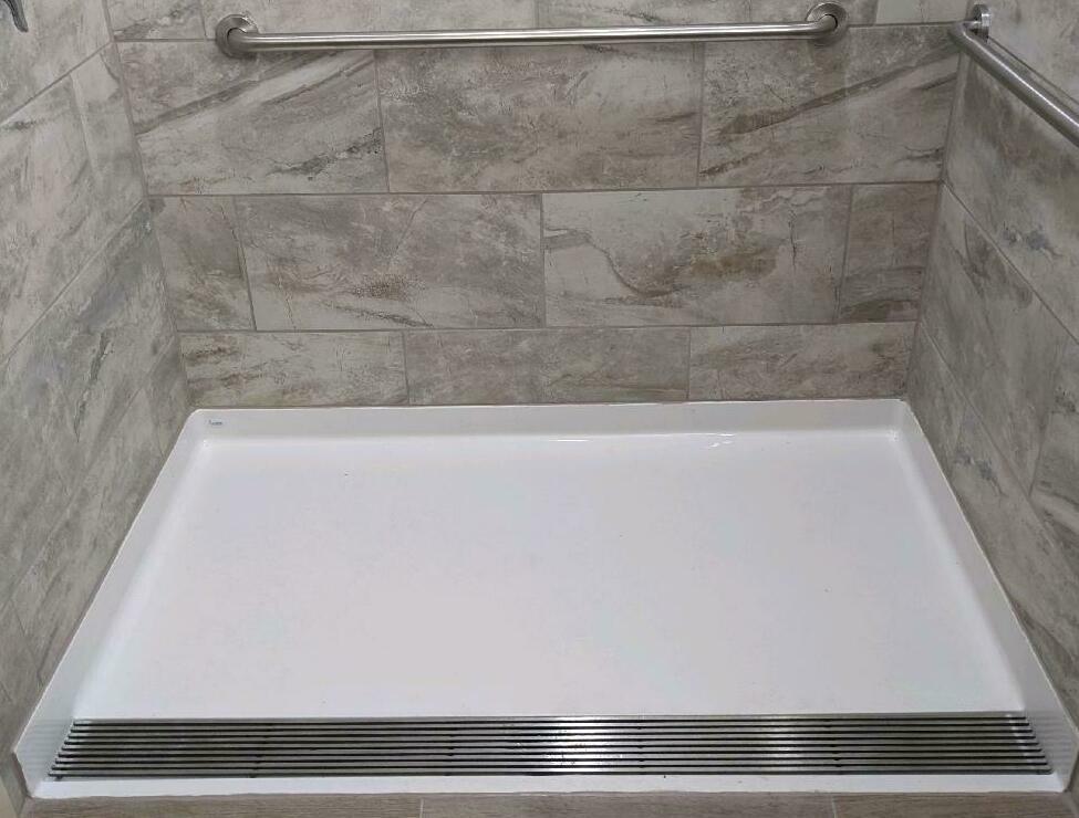 Roll in shower with grab bars.